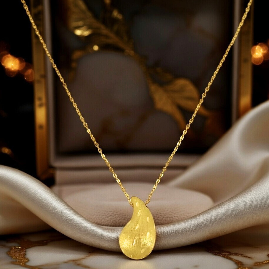 A single drop of liquid gold, textured by hand—pure elegance in motion.